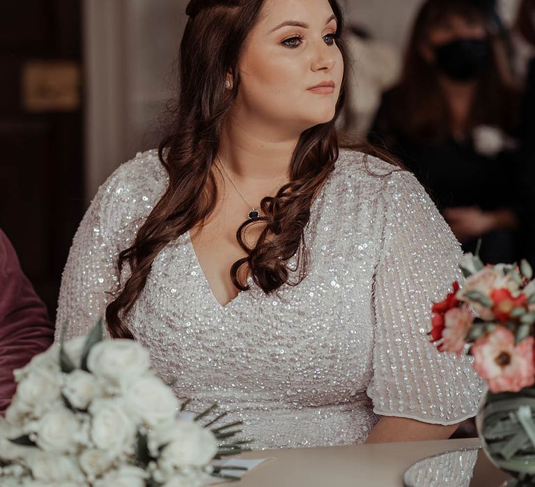 Bride wears her brown hair in loose curls on her wedding day