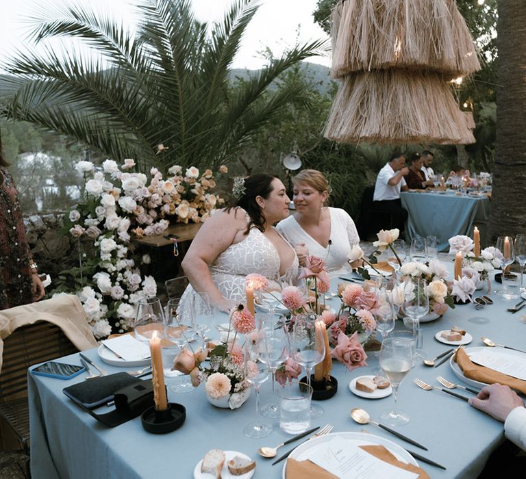 Brides at their Barcelona wedding reception with pastels, grey, mustard, pink and white theme table setting 