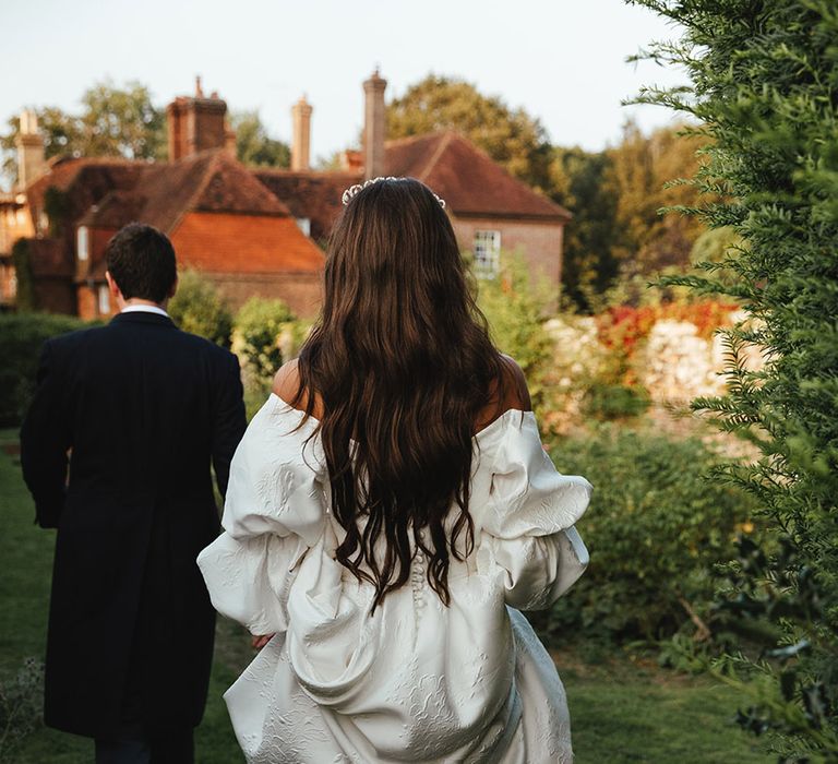 Bride in textured, long sleeve and buttoned wedding dress from Emma Beaumont 