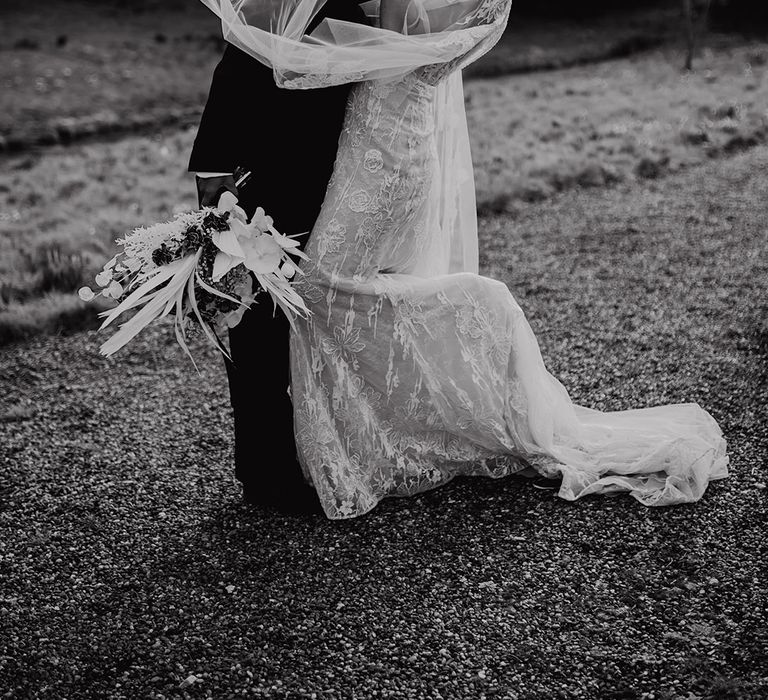 Black tie wedding with tuxedo and lace wedding dress with Watteau train 