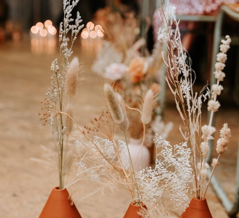 Handpainted terracotta vases with dried flowers for autumnal wedding decor