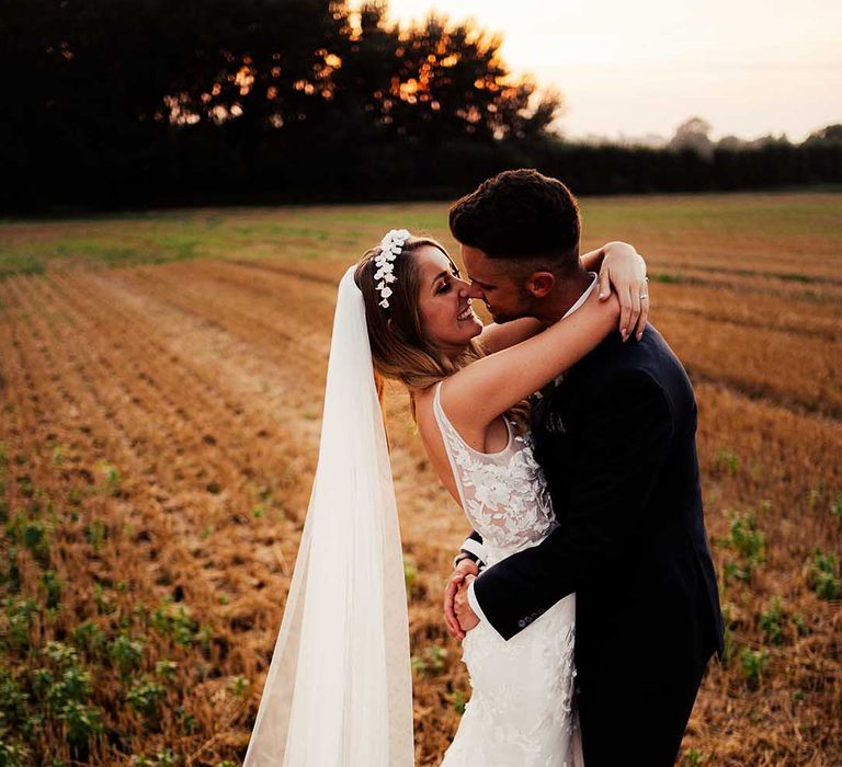 Bride and groom hug each other for their couple portraits after their wedding