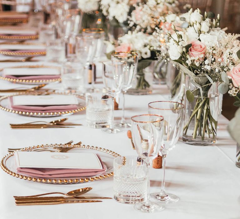 Pink, white and gold wedding colour palette with pink and white roses, gold cutlery, pink napkins and white stationery 