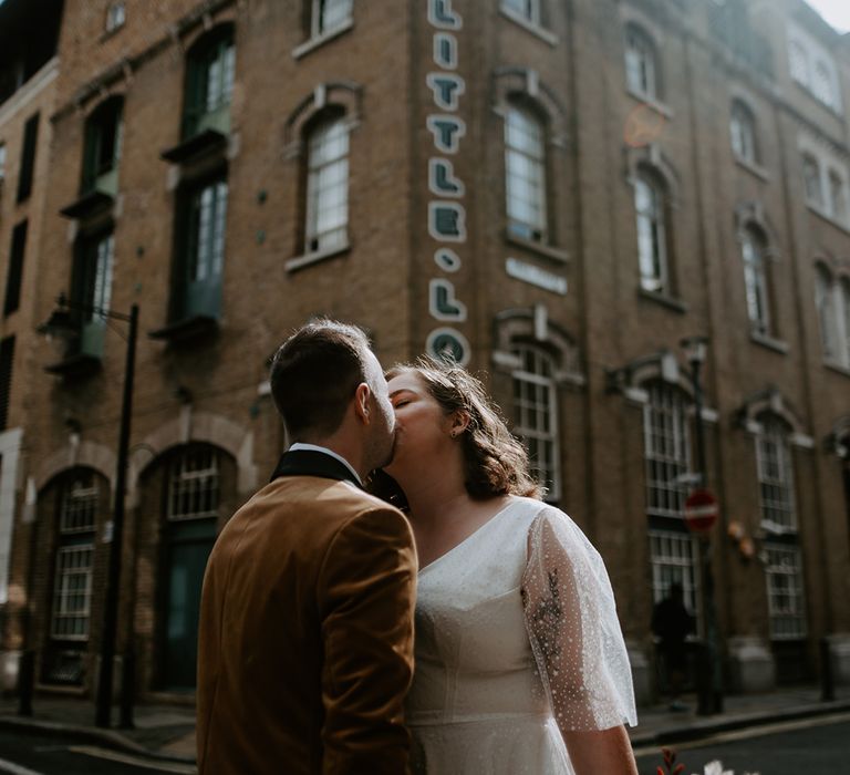 Bride and Groom kiss in the streets at London Wedding