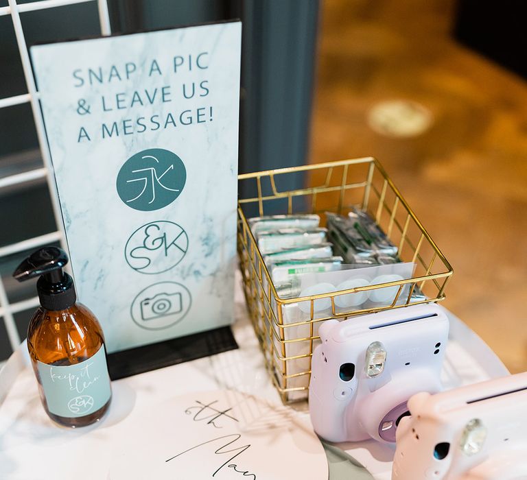 Wedding signage and polaroid cameras for alternative guest book idea 