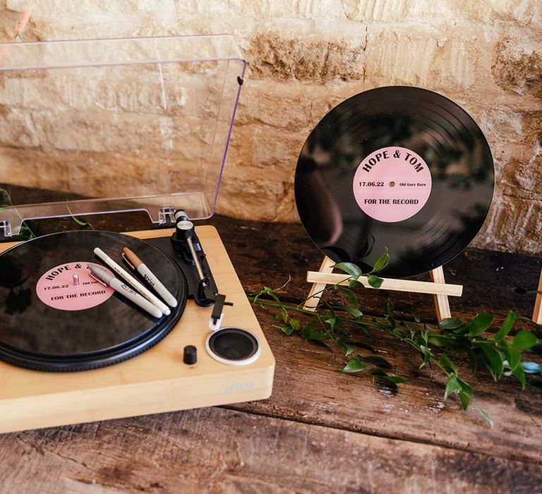 Personalised pink vinyl record and record player alternative wedding guest book at boho rock and roll wedding