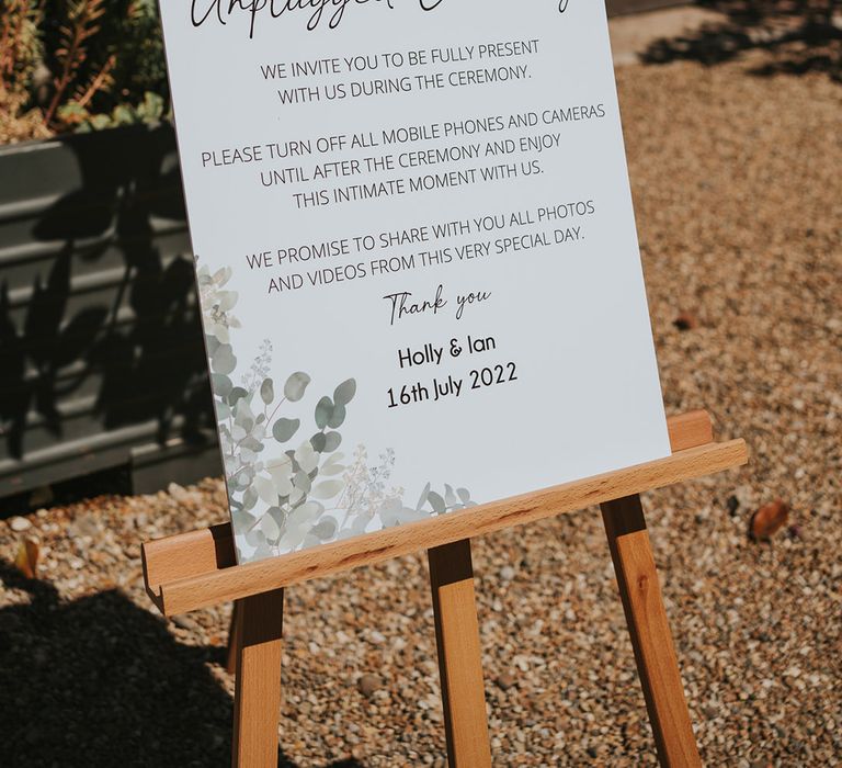 Black and white unplugged ceremony wedding sign with leaf design for eclectic rustic wedding with fairground and pastel pink and green wedding theme 