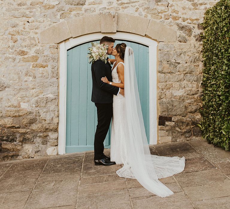 The bride and groom kiss for their couple portraits at Priston Mill, Bath 