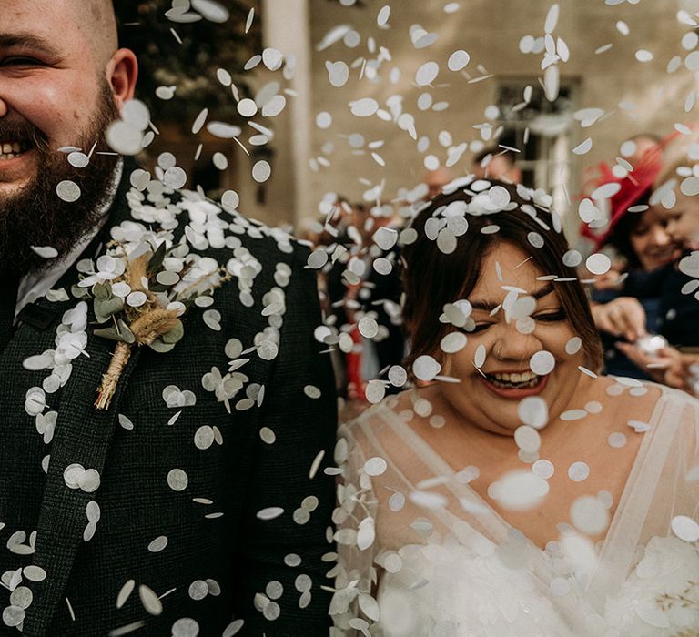 White confetti moment for the bride and groom as they exit from their civil wedding ceremony