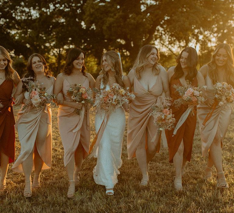 Bridesmaids in satin wrap bridesmaid dresses in autumnal colours for St Tewdrics Chepstow wedding 