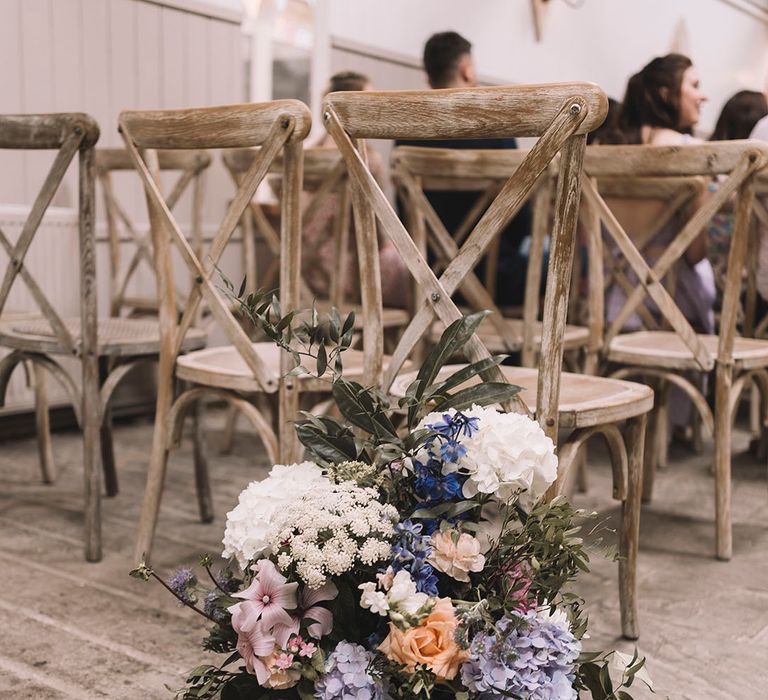 Hydrangeas and rose mallow in pastel shades made into an arrangement for the aisle flowers 