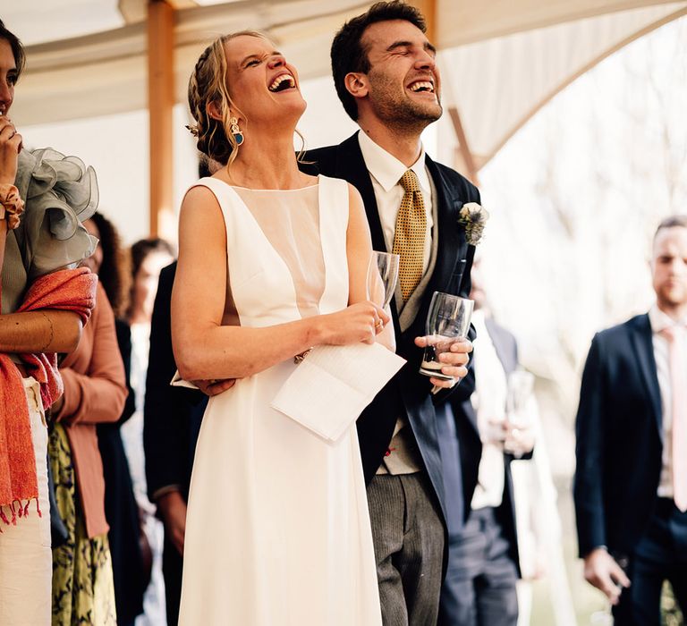 The bride and groom can't stop laughing at their wedding speeches 