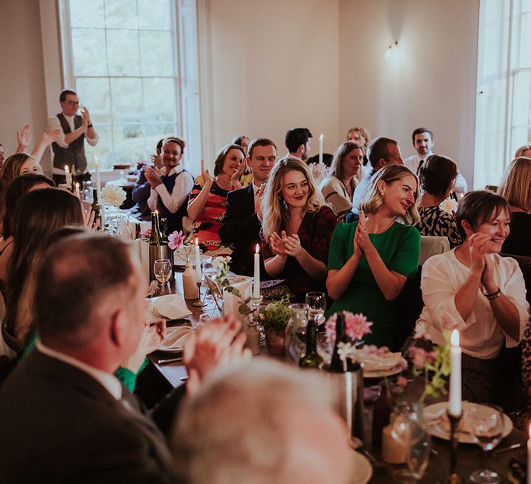 Wedding guests laugh at the wedding speeches at the Aswarby Rectory wedding 