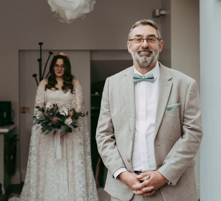 Father of the bride waits for this first look at the bride 