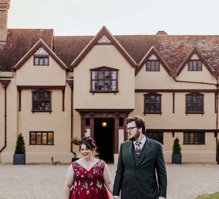 Ufton Court wedding venue with bride in princess red wedding dress with groom in forest green suit 