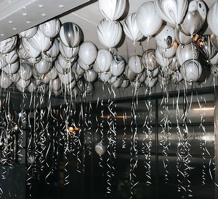 Image of balloons on the ceiling in silver, black and white shades for decoration by Miss Gen Photography