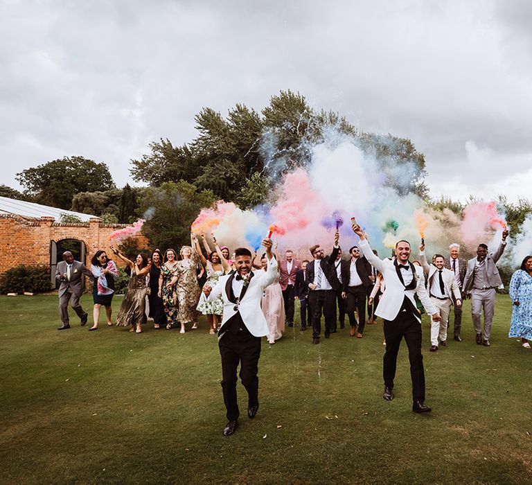 Colourful rainbow smoke bomb wedding photo idea for wedding party at interfaith same sex wedding 