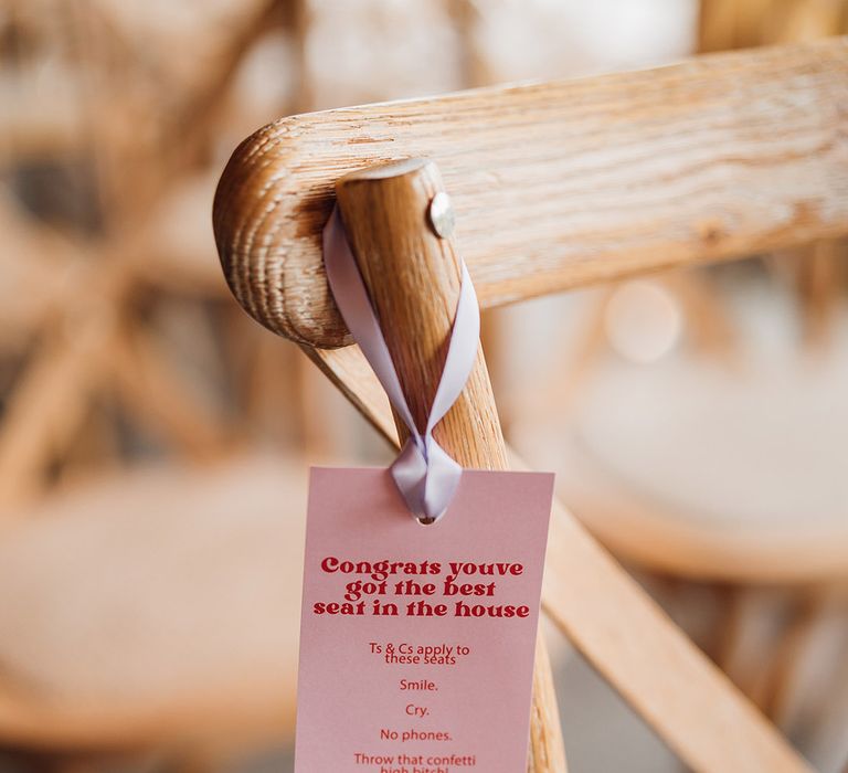 Red and pink reserve seat tags for the ceremony 