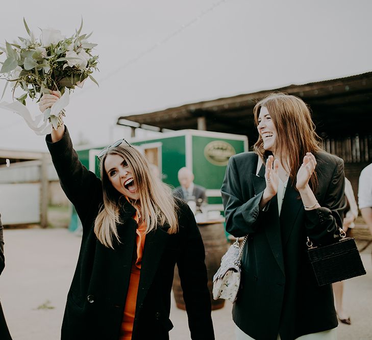 Wedding guest catching the bouquet 