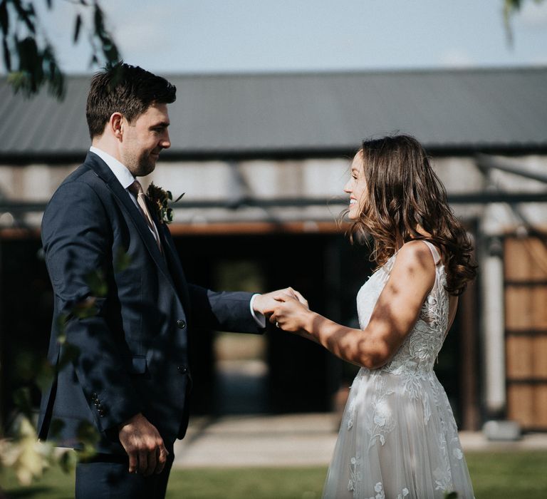 Bride and groom exchanging vows at outdoor humanist ceremony at Willow Marsh Farm