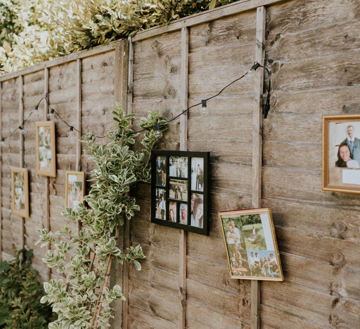 Photo frames decorating the fence at wedding reception at home