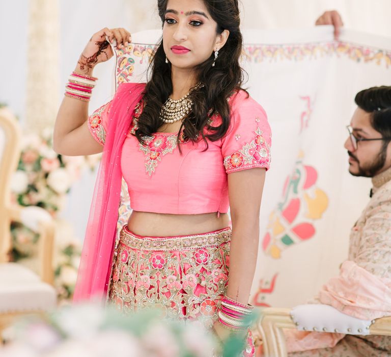 Wedding guest in pink embroidered sari 