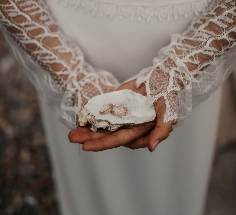 personalised wedding rings sitting in an oyster shell for coastal elopement 