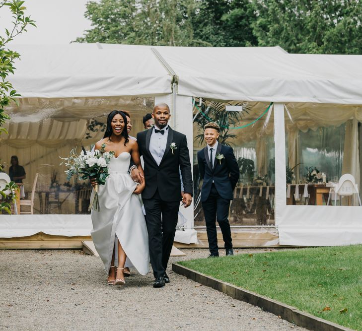 Bridal entrance in strapless Halfpenny London wedding dress