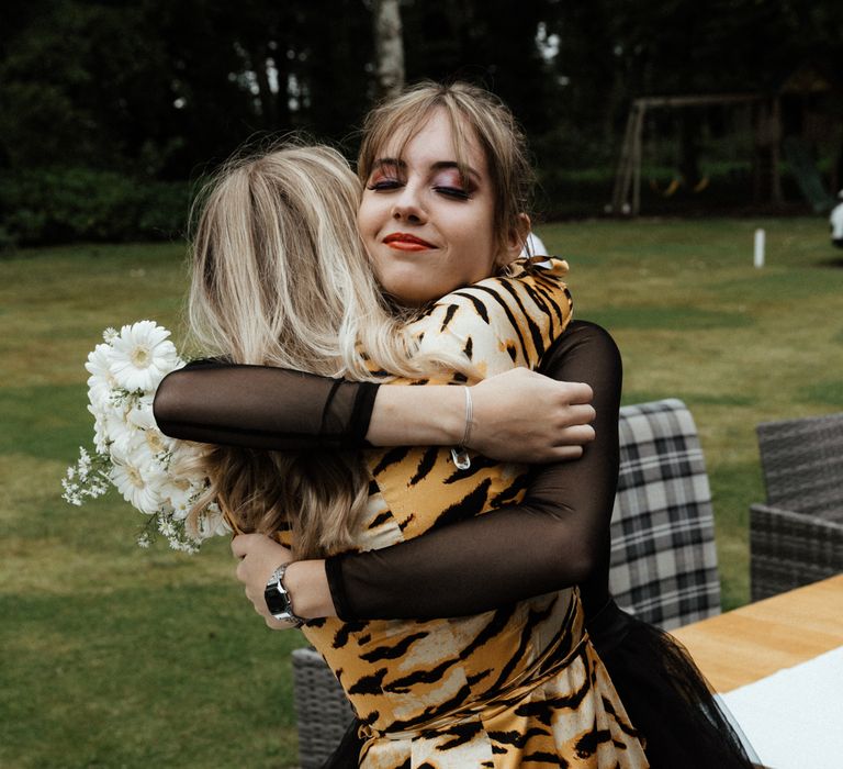 Bride embraces guest after wedding ceremony