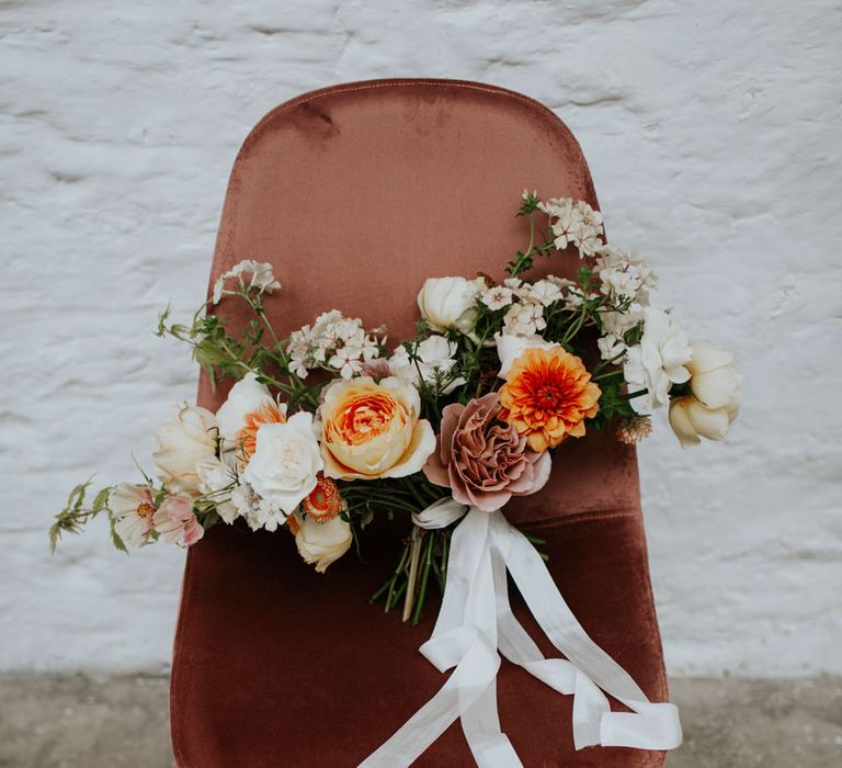 Dusty pink velvet chairs added a luxurious feel to the white and gold wedding shoot