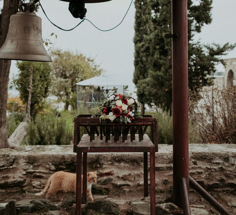 Church bells and a bouquet of red and white wedding flowers (plus a cat!)