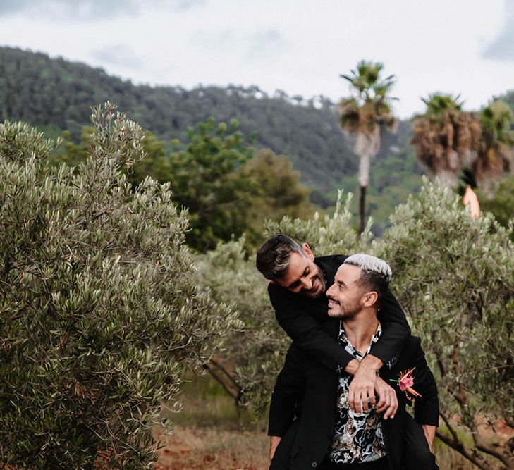 Portrait shot of grooms in black suits. Photography by Stephanie Shenton.