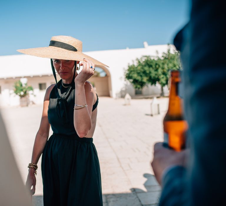 Chic wedding guest style, straw sunhat with black ribbon for Italian wedding