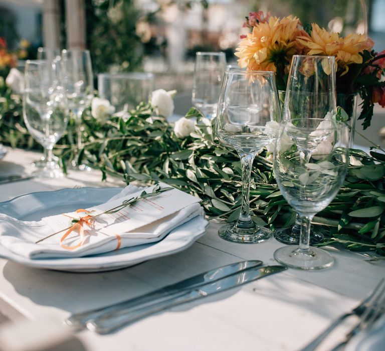 Olive leaf centrepieces with simple white tableware for rustic outdoor wedding