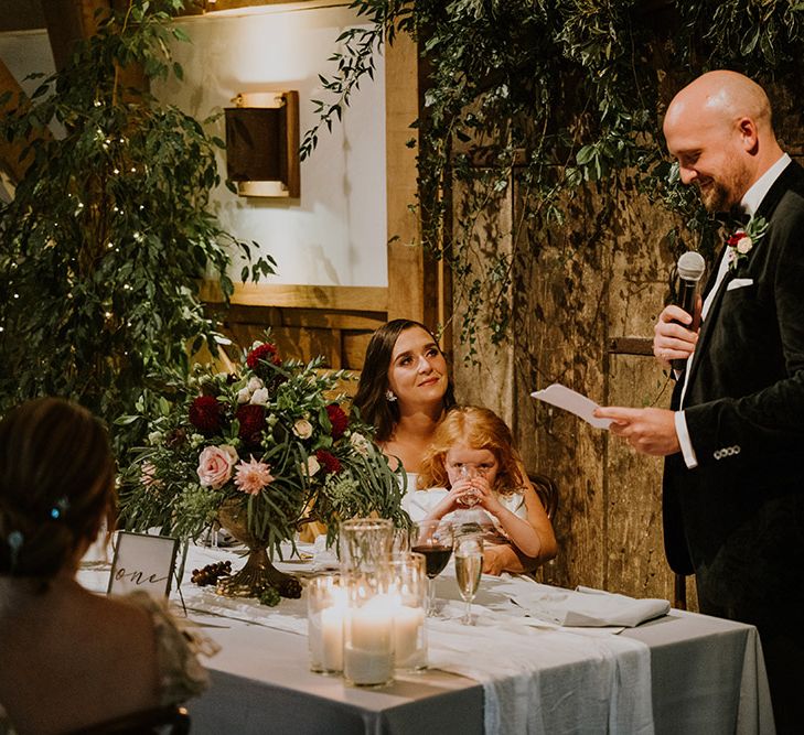 Groom in a velvet tuxedo delivering his wedding speech