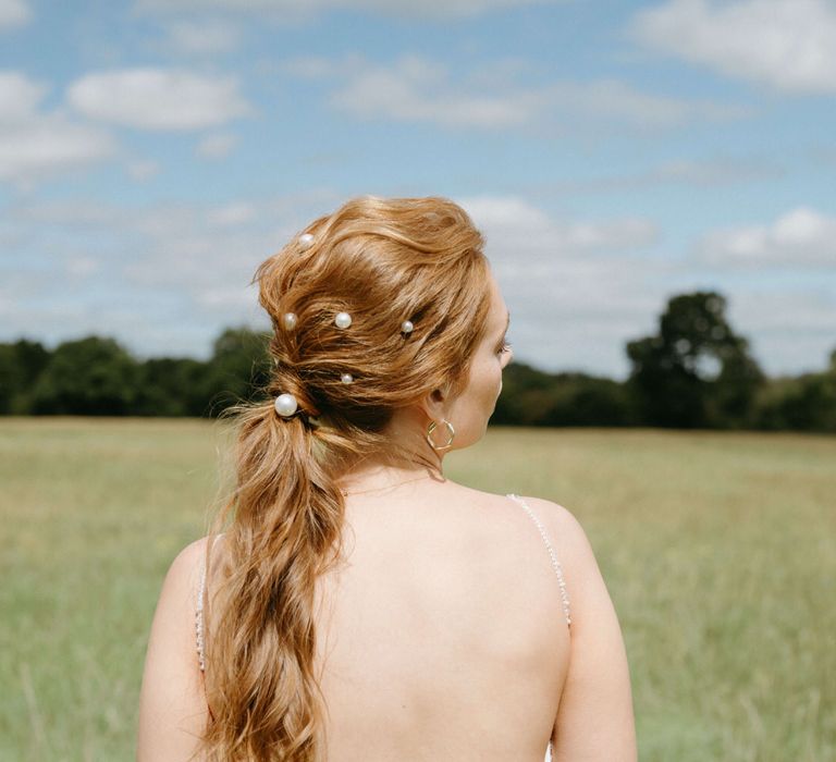 Relaxed bridal ponytail with pearl hair accessories