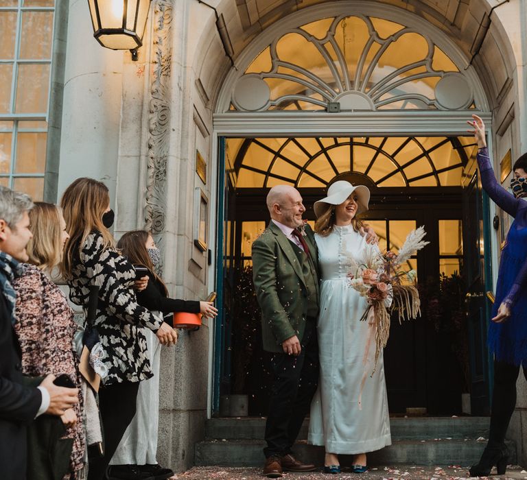 Bride & groom leave wedding ceremony with one another at the Chelsea Town Hall