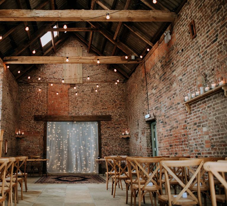 East Yorkshire Barns wedding venue decorated with a firelight curtain and festoon lights 