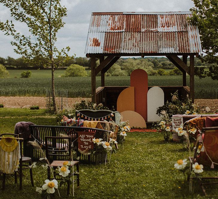 Sixties wedding inspiration with retro furniture, bold flowers, decor and signs