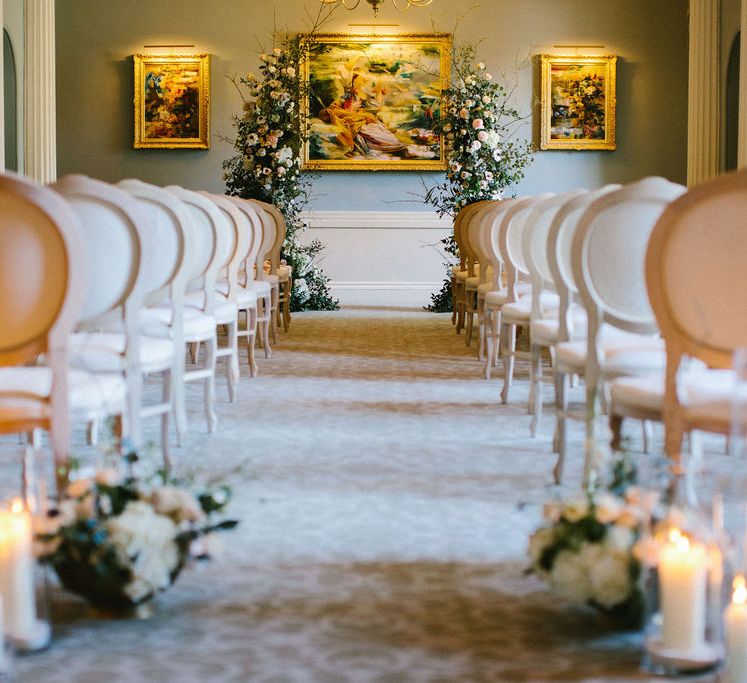 Ceremony room at Grantley Hall wedding venue with vertical floral arrangements 