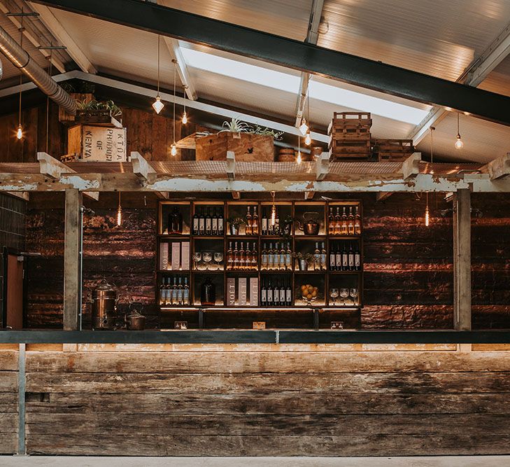 Wooden bar at new Lake District wedding venue, Gyhll Barn with industrial Edison bulb lights 