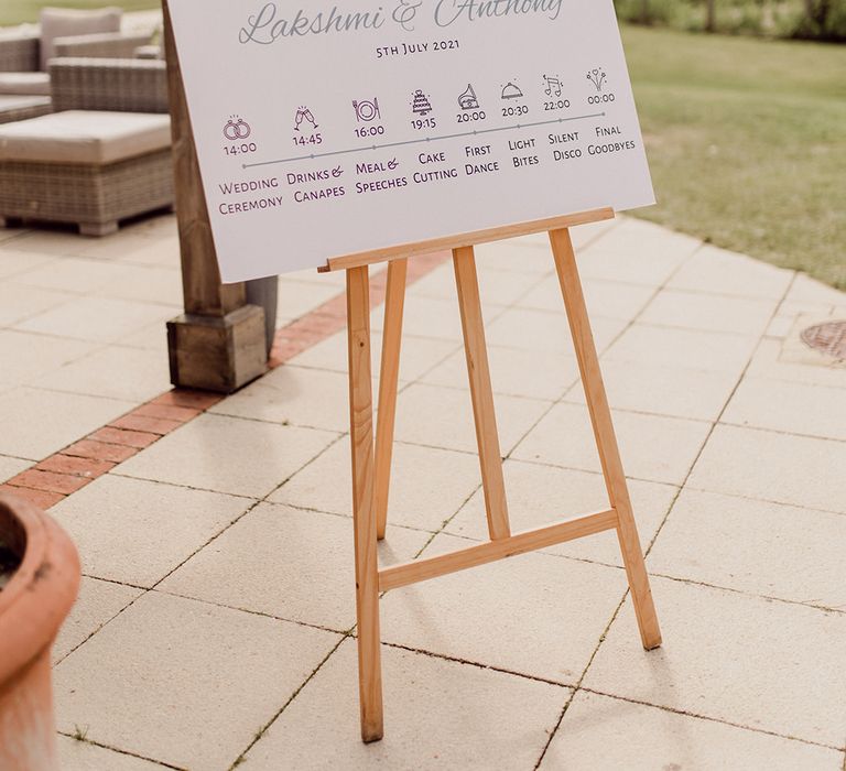 Welcome wedding sign complete with order of the day and names on a wooden easel  | Joshua Gooding Photography