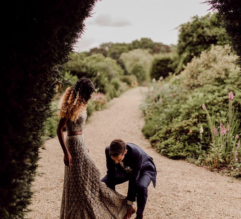 Groom helps his bride on their wedding day | Joshua Gooding Photography