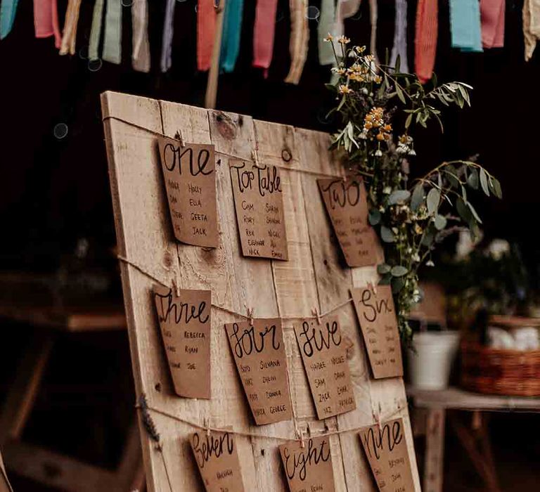 Bright tassel bunting with DIY table plan for festival wedding