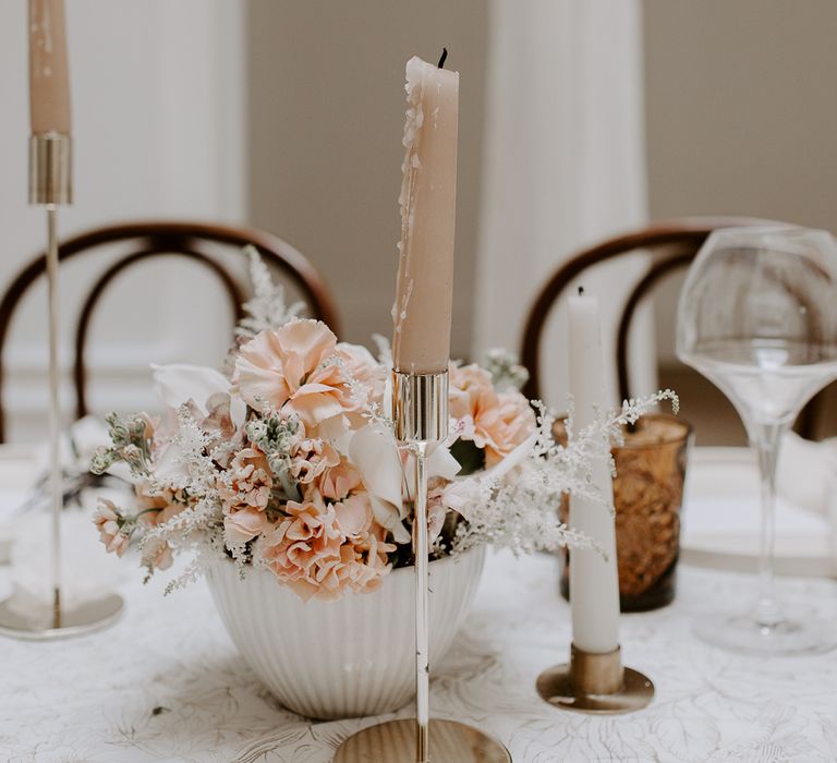 Wedding centrepiece with peach and white wedding flowers in ceramic pots 