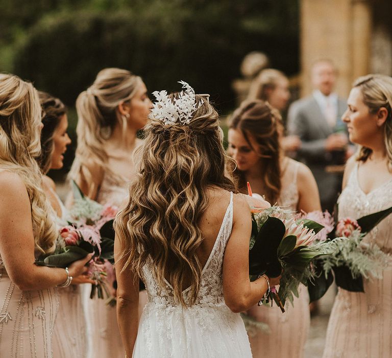 Bride wears her long hair in natural curls on her wedding day