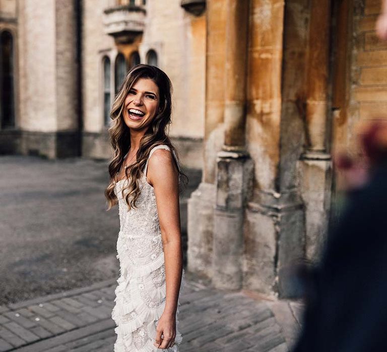 Bride laughs on her wedding day outdoors