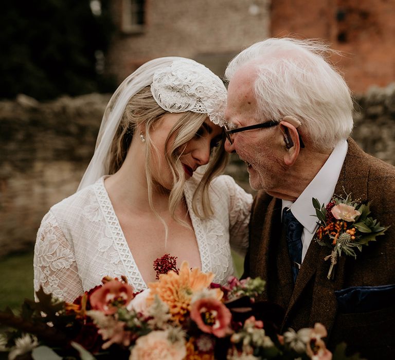 Bride in a lace wedding dress and Juliet cap veil with her grandfather in a brown wool suit 