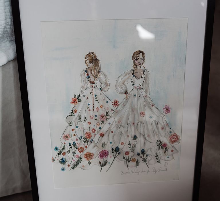 Framed illustration of long sleeve Victoria Sanders wedding dress with floral embroidery