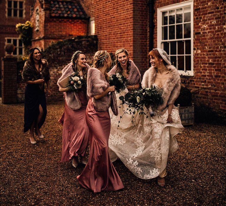 Pink bridesmaid dresses with faux fur wraps